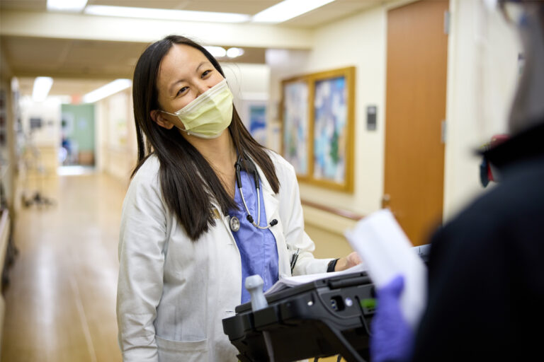 Hospitalist Joyce Ji, MD, talks with resident Umber Dube, MD, PhD.