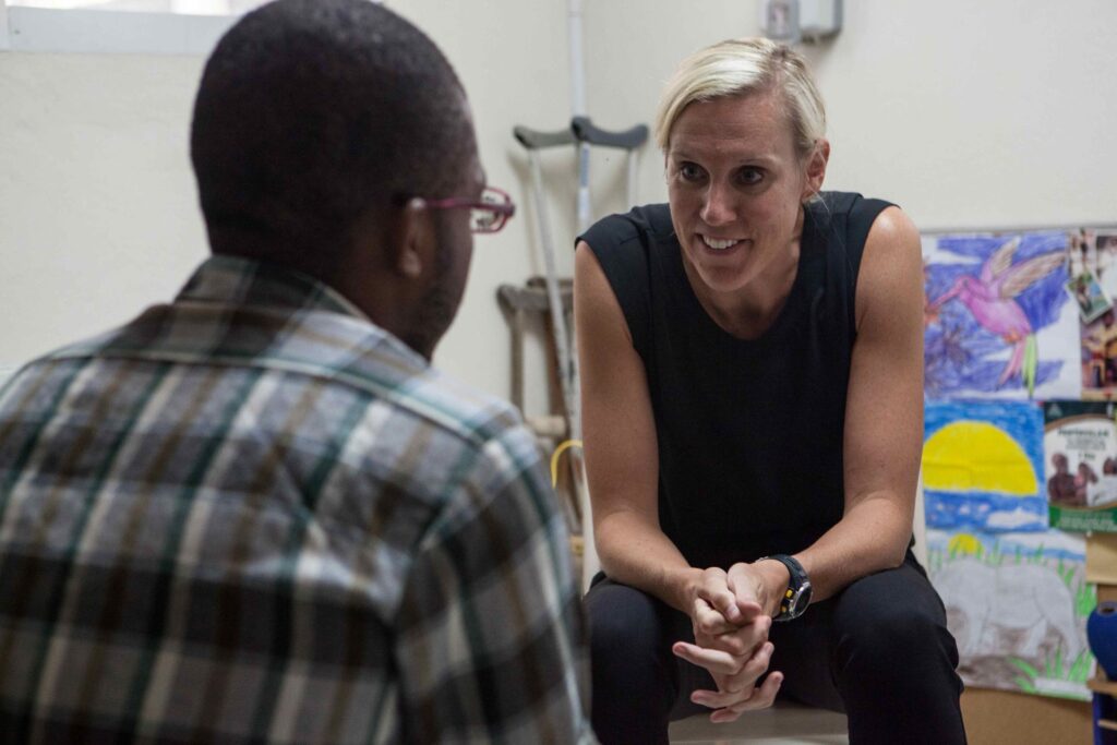 Dr. McNairy in Haiti speaking to a male.