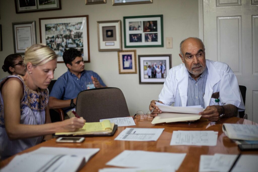 Dr. McNairy (left) working with others in Haiti.